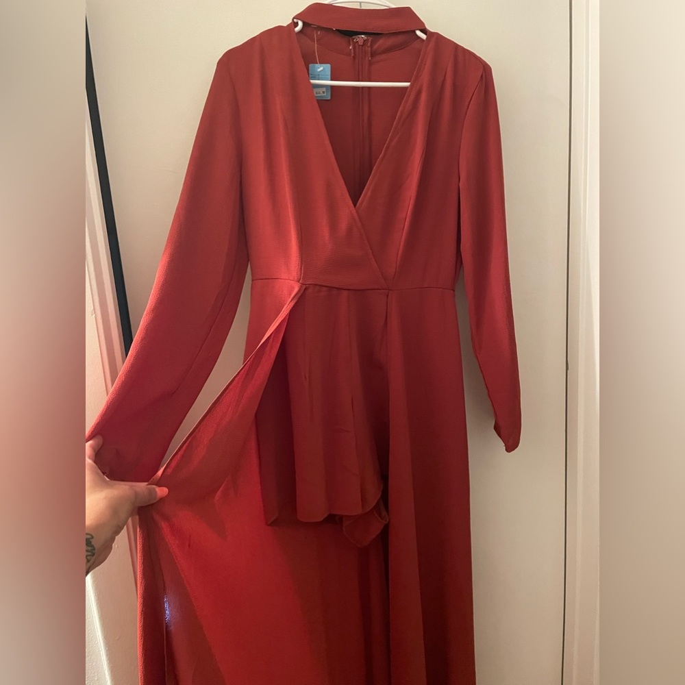 One piece, long sleeve shorts outfit with long tail. Perfect for a night out.